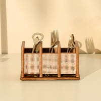 Wooden utensil holder with cutlery on a beige background